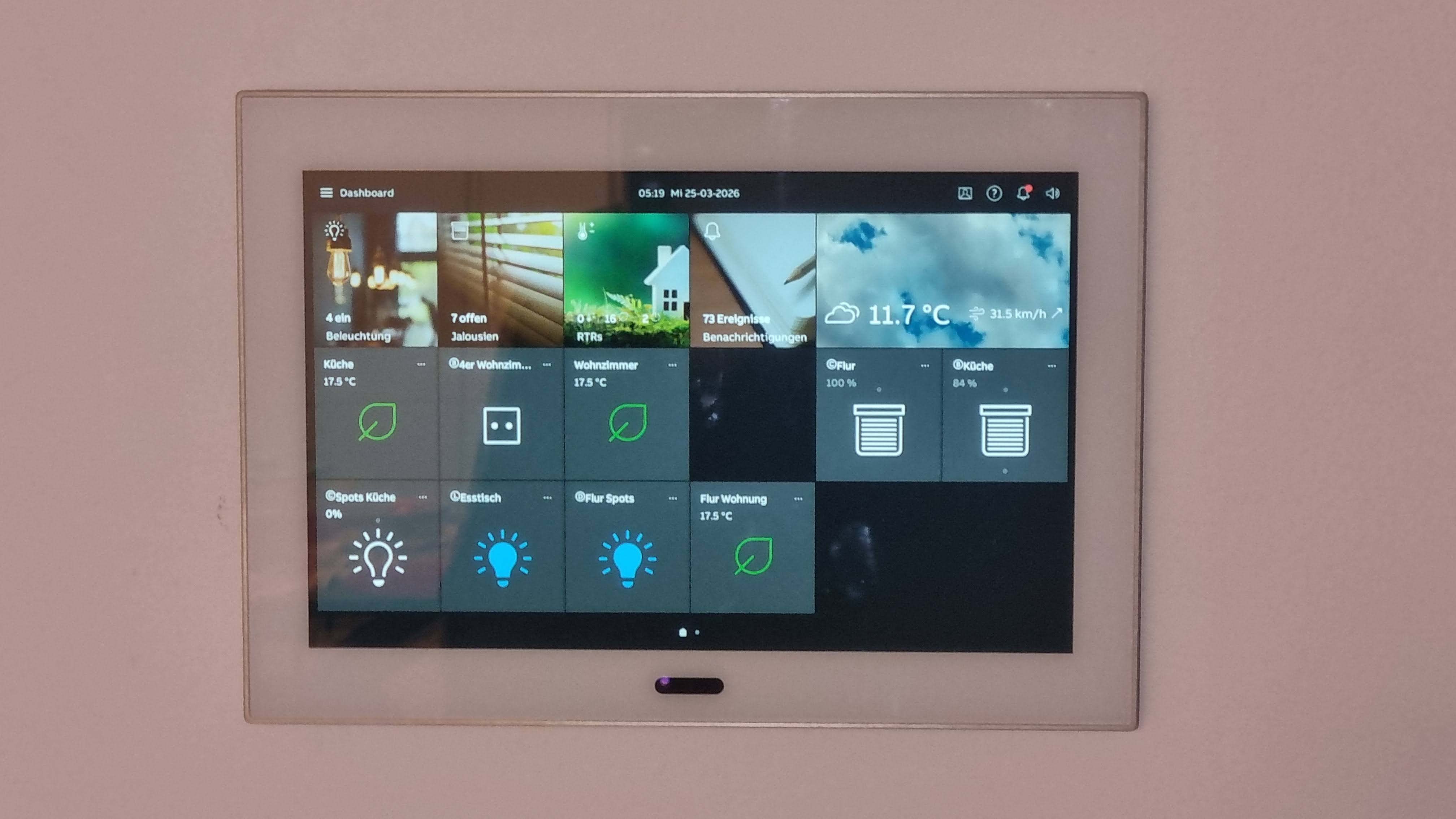 Ein Wandpanel mit Smart-Home-Steuerung zeigt Wetter und verschiedene Steuerfunktionen